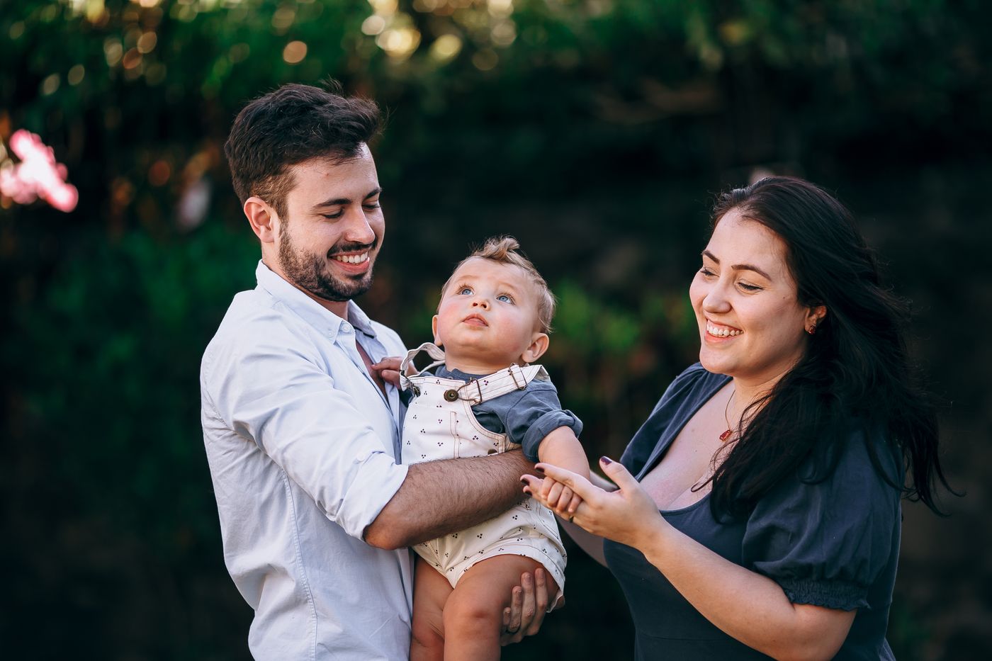 Parents lifting their baby and smiling
