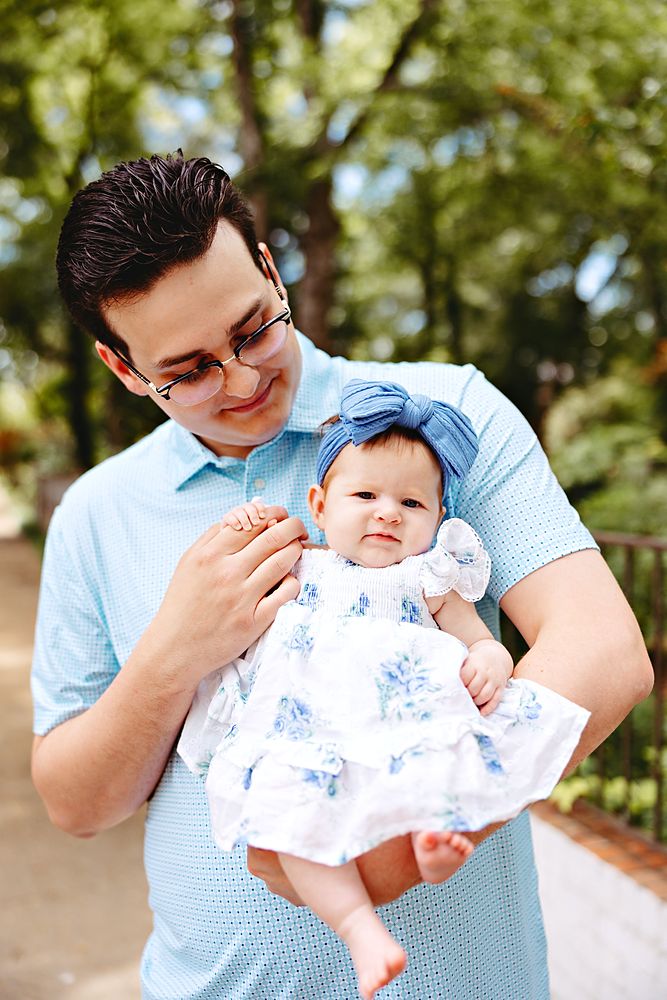 Dad holding his baby daughter