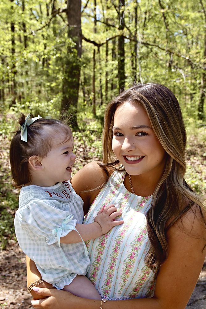 Mom and toddler laughing in the woods